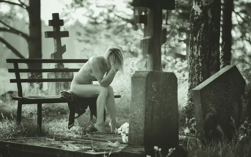 Naked woman sitting in the cemetery. My Fine Art Photography.
